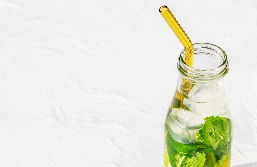 glass straw in bottle of ice drink